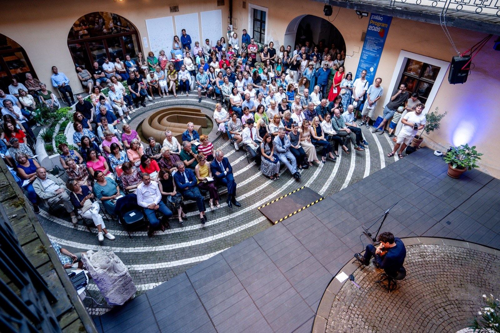 Emanuele Schillaci performing solo guitar to a full courtyard audience at Zichy Palace, Bratislava